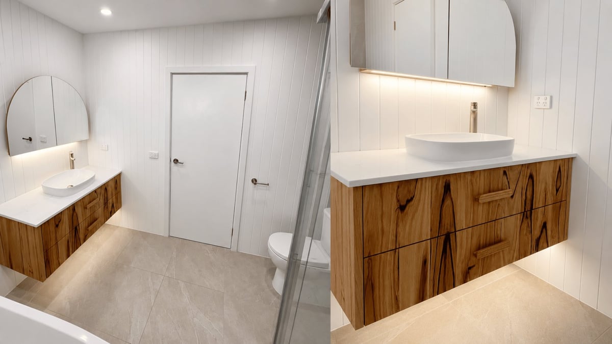 Bathroom renovation in Melbourne with dual wood vanities, white walls, floating mirror and toilet, completed by Absolute Bathroom Makeovers